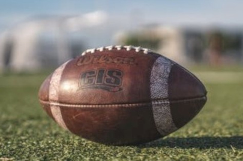 A close up of an american football on the field