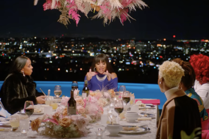 A group of people sitting at a table with food.