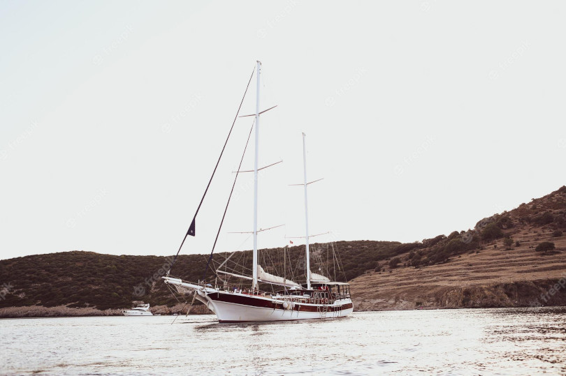 A white boat floating on top of water.