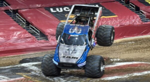 Monster truck performing a stunt on track.