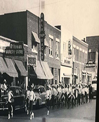 Historical street scene with marching group.