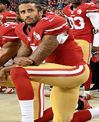 Kneeling football player in red uniform.