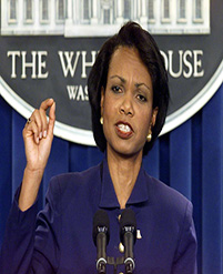 Woman speaking at a podium with microphones.