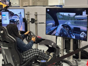 Person playing racing game in simulation setup.