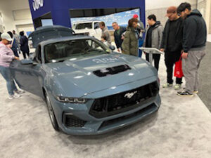 2024 Mustang on display with onlookers.