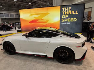 White sports car displayed at auto show.