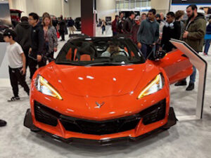 Orange sports car at an auto show.