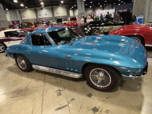 Classic blue sports car at car show.