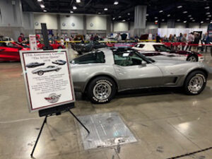 Silver Corvette at a car show.