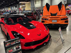 Red and orange sports cars at an exhibition.