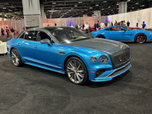 Luxury blue sports car at an auto show.