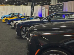 Row of luxury cars at an auto show.