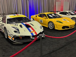 Race cars displayed behind velvet ropes.