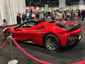 Red sports car at an auto show.