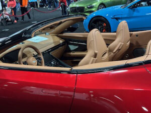 Red convertible car interior at auto show.