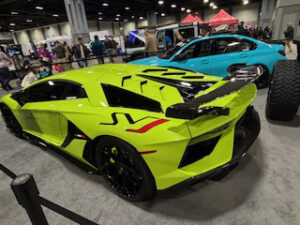 Bright green sports car at an auto show.