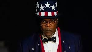 Man in patriotic outfit with starry hat.