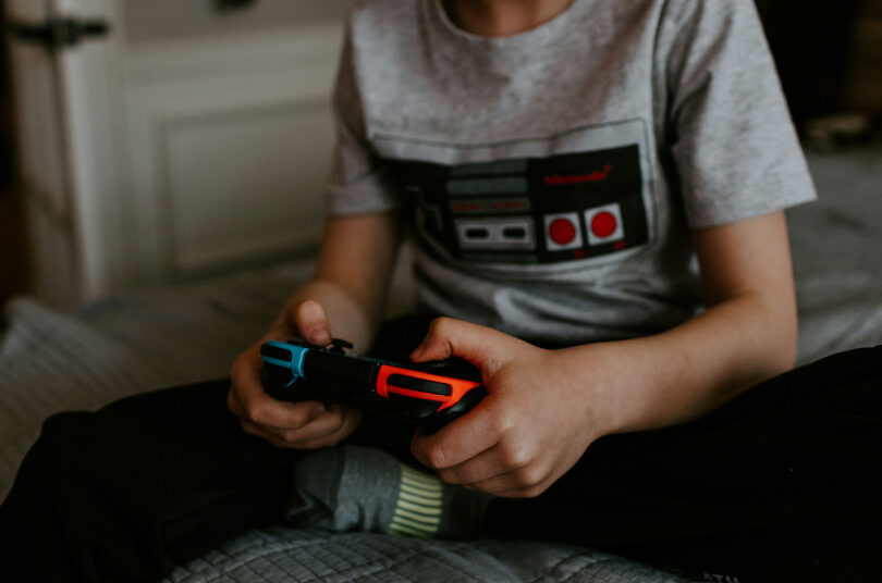 Child playing video game with controller.