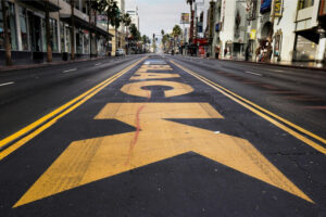 Empty street with "BLACK" painted large.