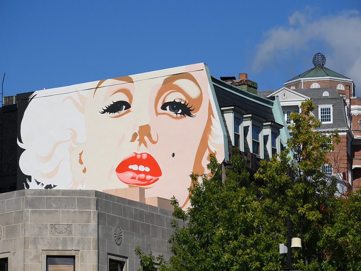 Building mural of a woman's face.