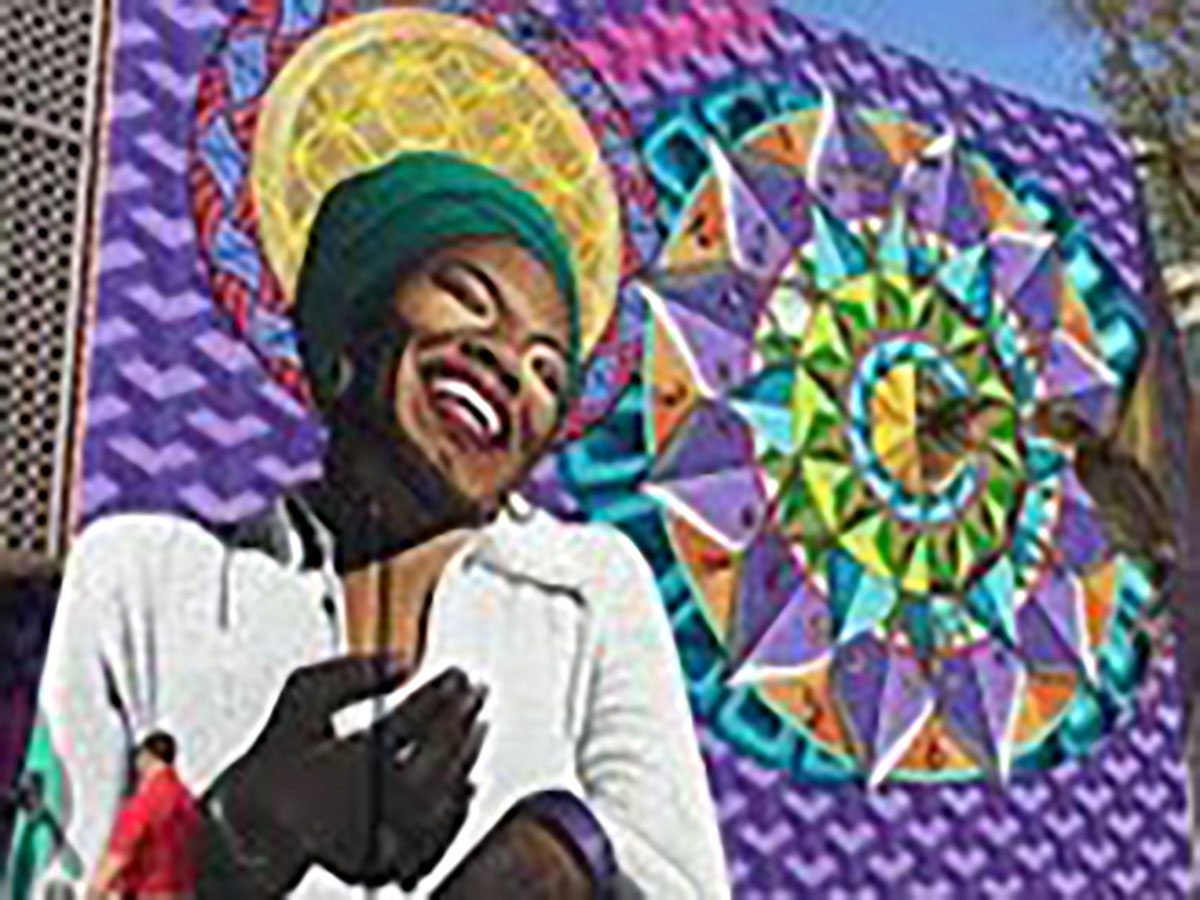 Colorful mural of smiling woman and patterns.