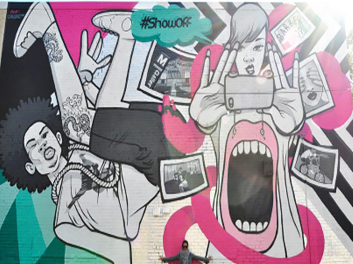 Colorful street art mural with expressive characters.