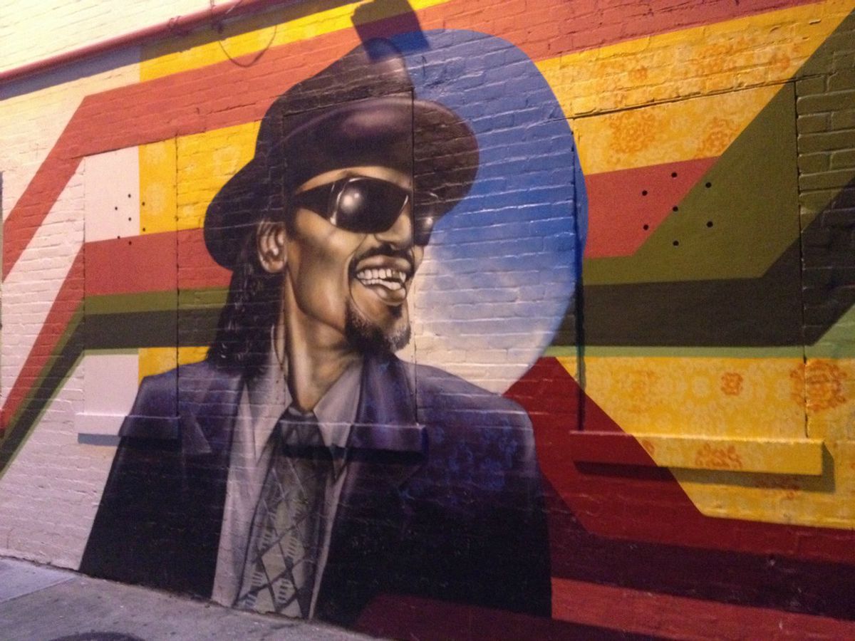 Colorful mural of a smiling man.