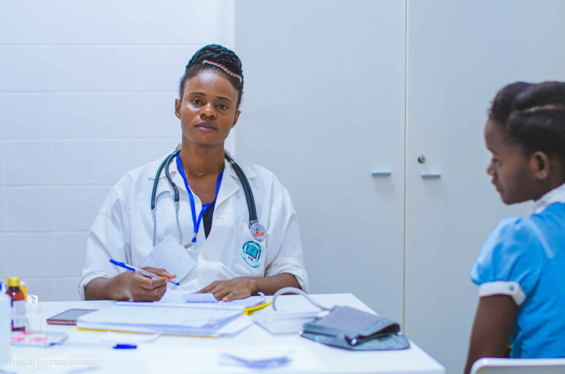 Doctor consulting with a young patient.